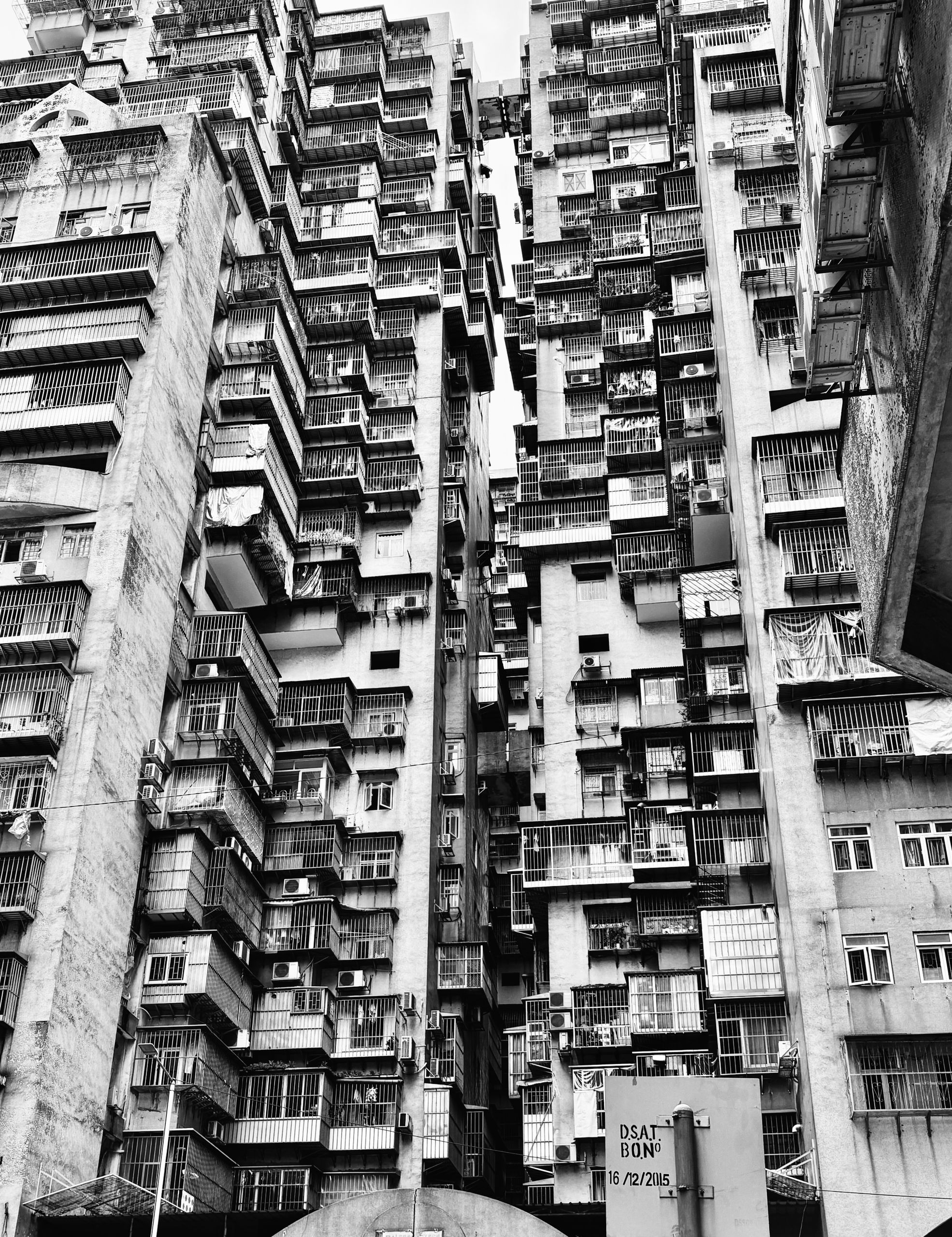 Black and white photo of densely packed high-rise buildings showcasing urban living.